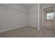 This walk-in closet has carpet flooring, built-in shelving, and natural light at 484 Charleston Pl, Villa Rica, GA 30180