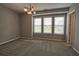 Spacious bedroom with neutral carpet, stylish lighting and bright windows at 6603 Sterling Dr, Atlanta, GA 30328