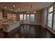 Open kitchen and dining area with hardwood floors and modern chandelier at 6603 Sterling Dr, Atlanta, GA 30328