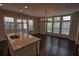 Open-concept kitchen with hardwood floors, island, modern lighting, and stainless steel sink at 6603 Sterling Dr, Atlanta, GA 30328