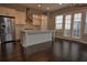 Bright kitchen featuring a large island, stainless steel fridge and white cabinets at 6603 Sterling Dr, Atlanta, GA 30328