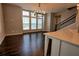 Cozy living room with hardwood floors, large windows, and staircase nearby at 6603 Sterling Dr, Atlanta, GA 30328
