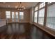 Bright living room featuring dark wood floors, large windows and a stylish chandelier at 6603 Sterling Dr, Atlanta, GA 30328