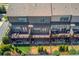 Aerial view of townhomes with decks and fenced backyards with artificial turf at 1005 Milhaven Dr, Roswell, GA 30076