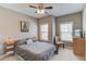 Relaxing bedroom featuring a ceiling fan, two windows and natural light at 1005 Milhaven Dr, Roswell, GA 30076