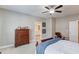 Spacious bedroom with a wood frame bed, dresser, a ceiling fan, and an ensuite bathroom at 1005 Milhaven Dr, Roswell, GA 30076