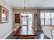 Elegant dining room with a large wooden table, stylish lighting, and views of the living area, ideal for gatherings at 1005 Milhaven Dr, Roswell, GA 30076