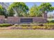 Harlow West brick entrance sign surrounded by landscaped shrubs and trees at 1005 Milhaven Dr, Roswell, GA 30076