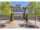 Charming townhome with a two-car garage, manicured landscaping, and classic architectural details at 1005 Milhaven Dr, Roswell, GA 30076