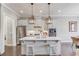 Modern kitchen with a center island, stainless steel appliances, and elegant pendant lighting, perfect for culinary enthusiasts at 1005 Milhaven Dr, Roswell, GA 30076