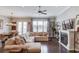 Inviting living room with a cozy fireplace, hardwood floors, and stylish furnishings, perfect for relaxing and entertaining at 1005 Milhaven Dr, Roswell, GA 30076