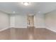 Large open living room with hardwood floors, neutral walls, and access to the staircase at 1005 Milhaven Dr, Roswell, GA 30076