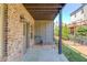 Covered brick patio with stone flooring and easy access to the backyard at 1005 Milhaven Dr, Roswell, GA 30076