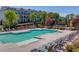 Beautiful community pool with lounge chairs, landscaping, and a view of the attractive townhome community at 1005 Milhaven Dr, Roswell, GA 30076