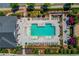 Aerial view of a community pool surrounded by trees, greenery, tables, and chairs at 1005 Milhaven Dr, Roswell, GA 30076