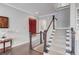 Bright foyer with staircase featuring hardwood floors, white trim, and natural light at 1005 Milhaven Dr, Roswell, GA 30076