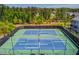 Aerial view of meticulously maintained community tennis courts surrounded by lush greenery at 1005 Milhaven Dr, Roswell, GA 30076