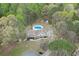 Aerial view of a private backyard featuring a sparkling in-ground pool surrounded by lush greenery at 1484 W Prospect Dr, Lawrenceville, GA 30043