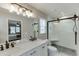 Bathroom with double sinks and walk-in shower with modern fixtures and natural light at 1484 W Prospect Dr, Lawrenceville, GA 30043