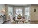 This light-filled dining area features a wood table, white chairs, and sliding doors to the deck at 1484 W Prospect Dr, Lawrenceville, GA 30043