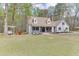 Quaint two-story home features a welcoming front porch, complemented by a swing and lush greenery at 1484 W Prospect Dr, Lawrenceville, GA 30043