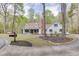 Inviting home with a circular driveway, a classic mailbox, and lush landscaping at 1484 W Prospect Dr, Lawrenceville, GA 30043