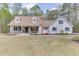 Charming home with a well-manicured lawn, dormer windows, and rocking chairs on the inviting front porch at 1484 W Prospect Dr, Lawrenceville, GA 30043