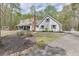 Charming two-story home with a long driveway and a detached garage nestled among mature trees at 1484 W Prospect Dr, Lawrenceville, GA 30043