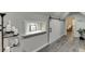 Hallway featuring hardwood floors, modern lighting, and a sliding barn door for added style and functionality at 1484 W Prospect Dr, Lawrenceville, GA 30043