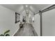 Hallway featuring hardwood floors, modern lighting, and sliding barn door for added style and functionality at 1484 W Prospect Dr, Lawrenceville, GA 30043