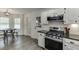 Modern kitchen with stainless steel appliances, range, and eat-in breakfast nook at 1484 W Prospect Dr, Lawrenceville, GA 30043