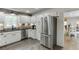 Eat-in kitchen featuring white cabinets, stainless steel appliances, and a view to the dining area at 1484 W Prospect Dr, Lawrenceville, GA 30043