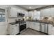 This kitchen features white cabinets, stainless steel appliances, and modern fixtures at 1484 W Prospect Dr, Lawrenceville, GA 30043