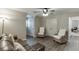 Spacious living room with hardwood floors, a comfortable leather sofa, and two inviting wicker chairs at 1484 W Prospect Dr, Lawrenceville, GA 30043