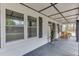 Inviting porch with wood flooring, decorative lights and wood-framed windows, creating a cozy outdoor space at 1484 W Prospect Dr, Lawrenceville, GA 30043