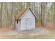 Charming outdoor shed with white siding nestled among trees at 1484 W Prospect Dr, Lawrenceville, GA 30043