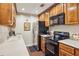 Compact kitchen featuring a stainless steel refrigerator, wooden cabinets, and essential appliances at 3201 Lenox Ne Rd # 22, Atlanta, GA 30324