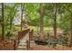 A charming wooden bridge over a creek, nestled in a verdant, park-like setting at 3201 Lenox Ne Rd # 22, Atlanta, GA 30324