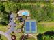 Aerial view of a community pool and tennis courts surrounded by lush greenery and trees at 480 Springs End Ne Ln, Marietta, GA 30068