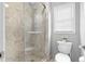 Shower featuring tiled walls, and toilet with window, and a glass enclosure at 480 Springs End Ne Ln, Marietta, GA 30068