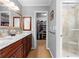 Bathroom with dual sinks, marble countertops, and a glass-enclosed shower at 480 Springs End Ne Ln, Marietta, GA 30068