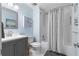Bright bathroom features a gray vanity, patterned shower curtain, and tiled shower at 480 Springs End Ne Ln, Marietta, GA 30068