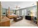 Light-filled bedroom with a four-poster bed, seating area, and neutral decor at 480 Springs End Ne Ln, Marietta, GA 30068