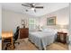 Comfortable bedroom showcasing a striped bedspread, ceiling fan and natural lighting at 480 Springs End Ne Ln, Marietta, GA 30068