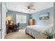Light-filled bedroom with a ceiling fan, soft blue walls, and comfortable workstation at 480 Springs End Ne Ln, Marietta, GA 30068