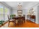 Bright dining room with hardwood floors, a chandelier, and a large window, perfect for entertaining and Gathering meals at 480 Springs End Ne Ln, Marietta, GA 30068