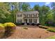 Inviting two-story home with a well-manicured lawn, mature trees, and a classic design, perfect for Gathering living at 480 Springs End Ne Ln, Marietta, GA 30068
