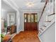Elegant foyer with hardwood floors, a staircase, and a beautifully crafted front door, setting a sophisticated tone at 480 Springs End Ne Ln, Marietta, GA 30068