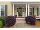 Close-up of the inviting front porch with manicured landscaping, creating a warm and welcoming entrance at 480 Springs End Ne Ln, Marietta, GA 30068