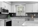 Bright kitchen featuring white cabinets, stainless appliances, and granite countertops at 480 Springs End Ne Ln, Marietta, GA 30068
